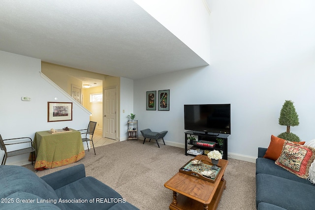 living room featuring a textured ceiling and carpet