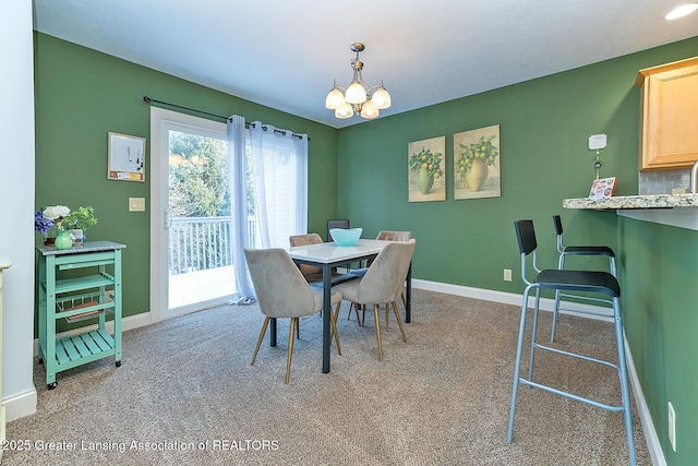 carpeted dining area with a notable chandelier