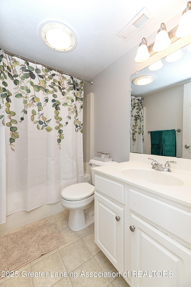 full bathroom featuring vanity, tile patterned floors, toilet, and shower / tub combo with curtain