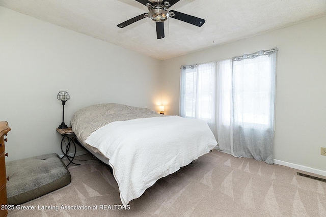 bedroom featuring light carpet and ceiling fan