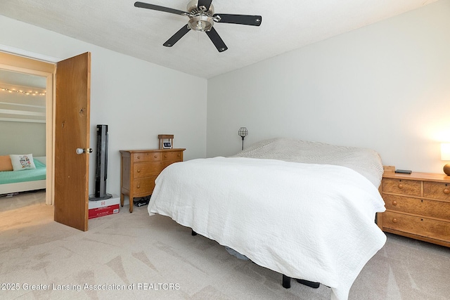 bedroom featuring light colored carpet and ceiling fan