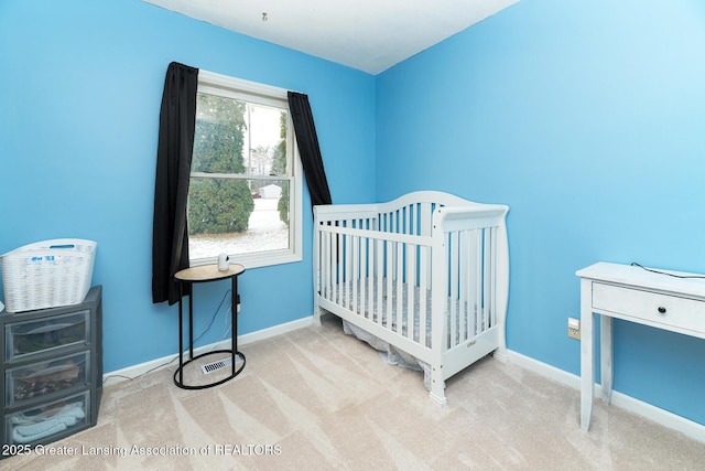 carpeted bedroom with a nursery area