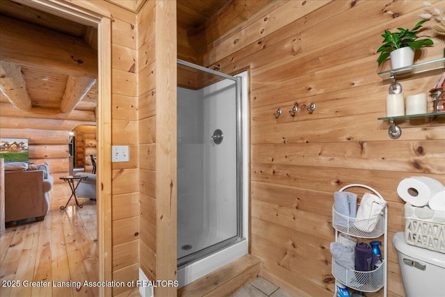 bathroom featuring log walls, wooden ceiling, an enclosed shower, and toilet