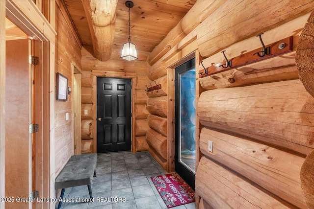 interior space featuring rustic walls and wooden ceiling