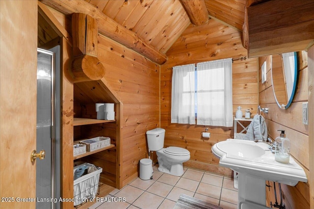 bathroom with toilet, tile patterned floors, wooden walls, and lofted ceiling with beams