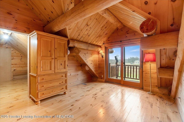 additional living space featuring wood ceiling, vaulted ceiling with beams, hardwood / wood-style flooring, and wood walls