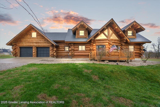 log cabin with a garage and a yard