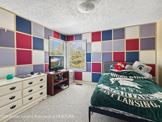 carpeted bedroom with a textured ceiling