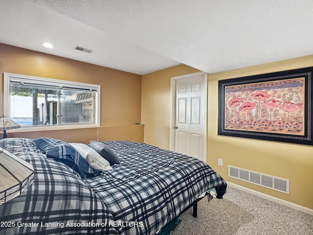 carpeted bedroom with a textured ceiling