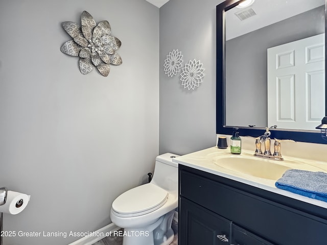 bathroom featuring vanity and toilet