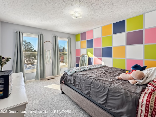 bedroom with carpet and a textured ceiling