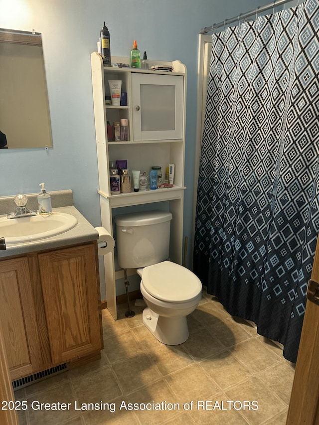 bathroom featuring tile patterned flooring, vanity, a shower with shower curtain, and toilet