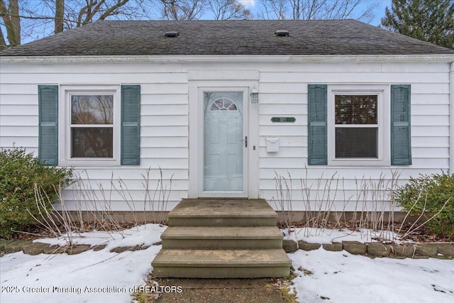 view of snow covered property entrance