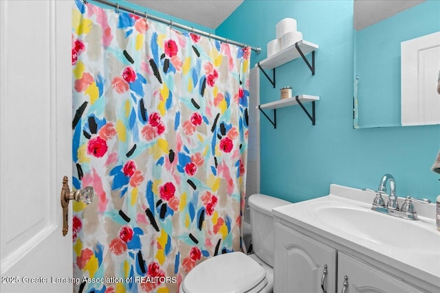 bathroom with vanity, curtained shower, and toilet