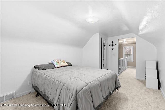 carpeted bedroom featuring vaulted ceiling