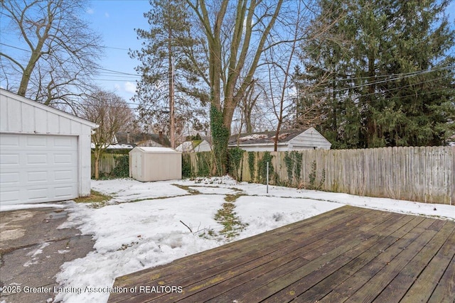 snow covered deck featuring a storage unit