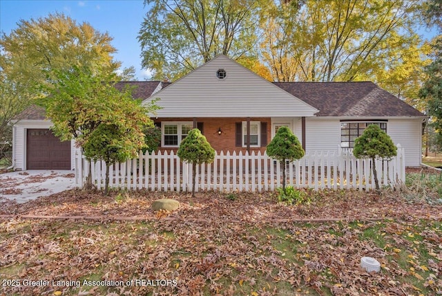 ranch-style home with a fenced front yard, an attached garage, and a shingled roof