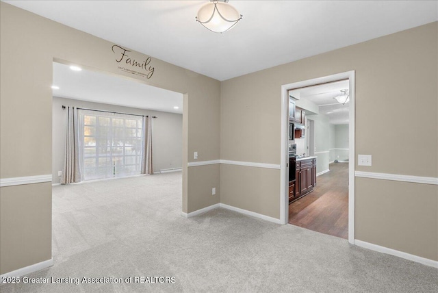 carpeted spare room featuring recessed lighting and baseboards