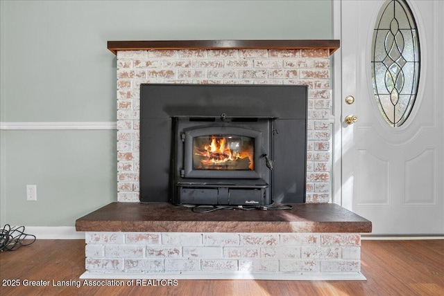 details featuring wood finished floors and baseboards