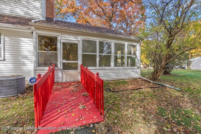 deck featuring central air condition unit and a sunroom