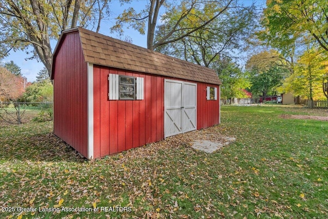 view of shed featuring fence