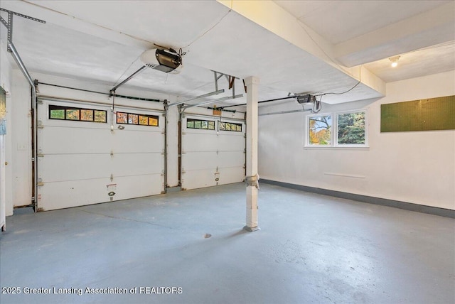 garage with a garage door opener and baseboards