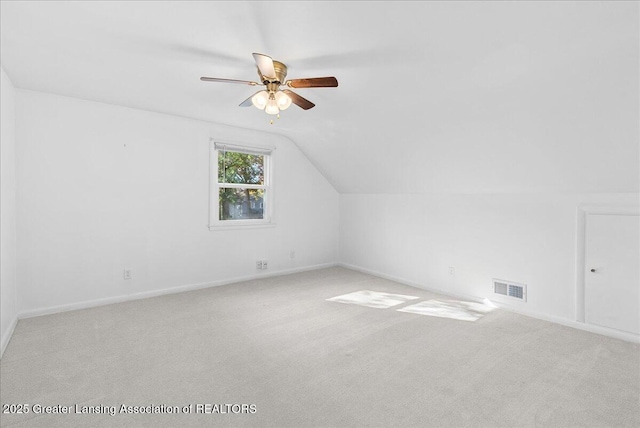 bonus room with baseboards, visible vents, ceiling fan, vaulted ceiling, and carpet flooring