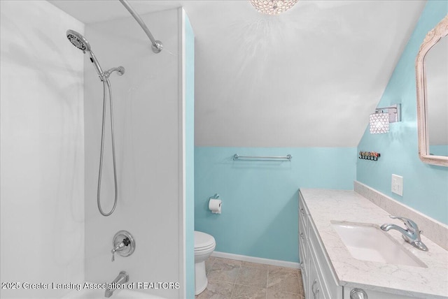 bathroom with vanity, baseboards, vaulted ceiling, shower / tub combination, and toilet