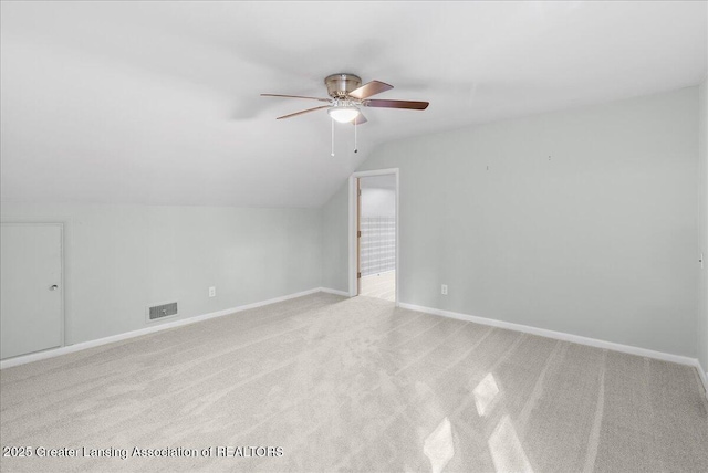 bonus room featuring visible vents, lofted ceiling, light colored carpet, and baseboards