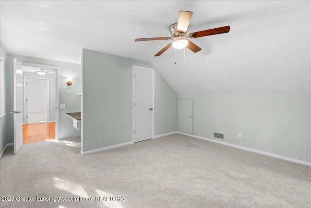 additional living space featuring visible vents, baseboards, lofted ceiling, and carpet floors