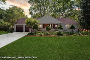 view of front of house featuring an attached garage, concrete driveway, and a front yard