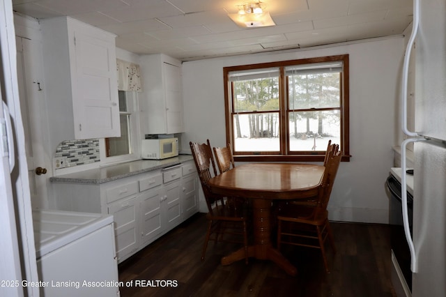 dining space featuring dark wood-type flooring