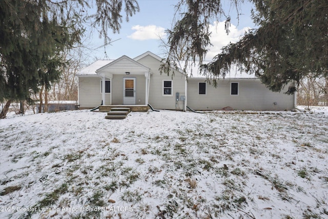 view of snow covered rear of property