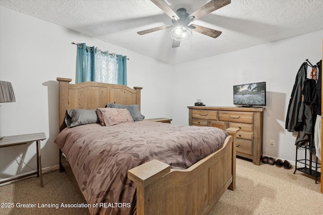 bedroom with ceiling fan and a textured ceiling