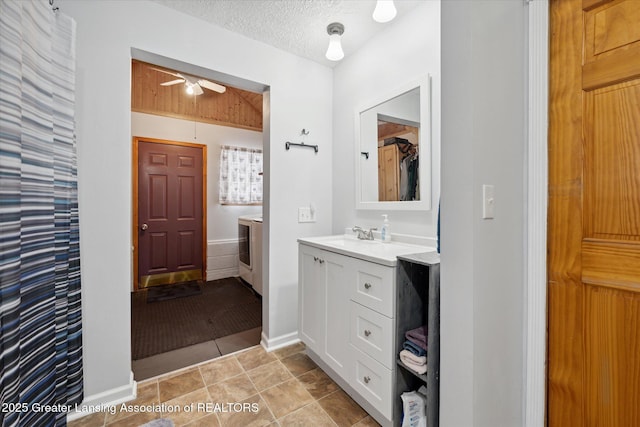 bathroom with ceiling fan, tile patterned floors, vanity, and a textured ceiling