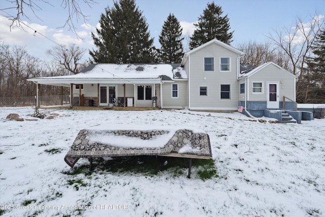 snow covered property with a porch