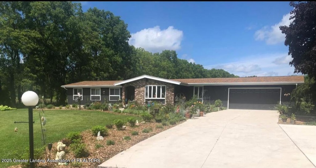 ranch-style home with a garage and a front yard