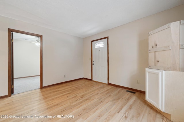 empty room with light hardwood / wood-style flooring