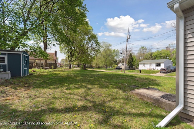 view of yard with an outbuilding and a shed