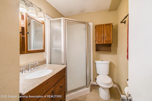 bathroom with vanity, toilet, and a shower with door