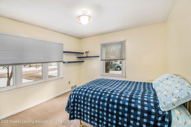 bedroom featuring light carpet