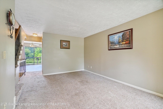 carpeted spare room featuring a textured ceiling