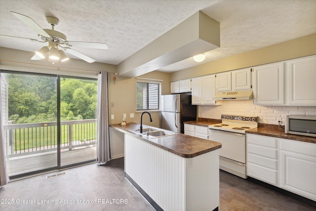 kitchen with appliances with stainless steel finishes, sink, white cabinets, decorative backsplash, and a textured ceiling