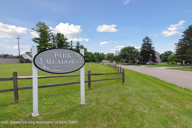 community / neighborhood sign with a lawn