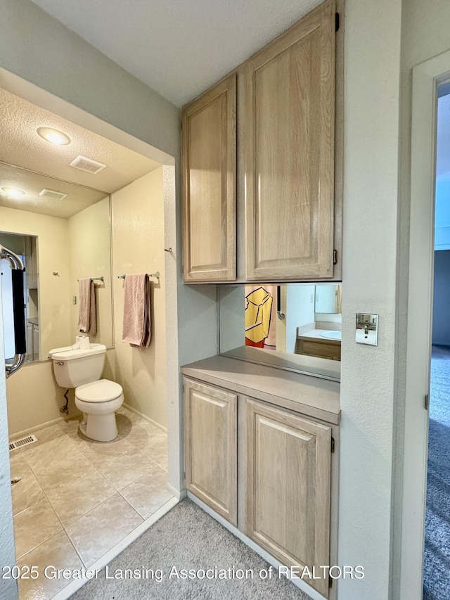 bathroom with tile patterned floors and toilet