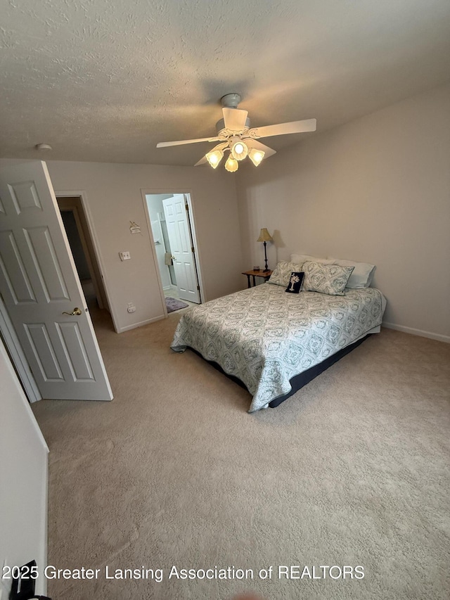 carpeted bedroom with ceiling fan and a textured ceiling