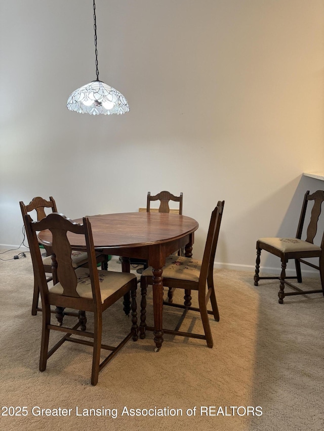 dining room featuring light carpet