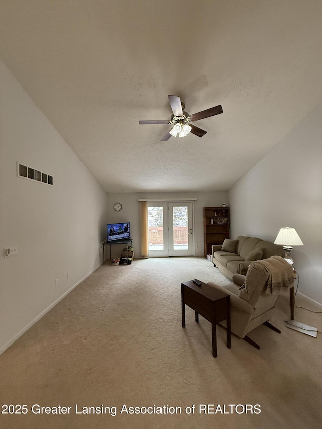 carpeted living room featuring vaulted ceiling and ceiling fan