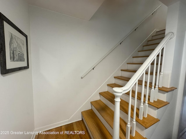 stairs featuring wood-type flooring