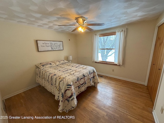 bedroom with wood-type flooring and ceiling fan